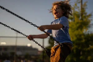 Child on a swing in a playground