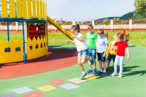 Children playing hopscotch in playground