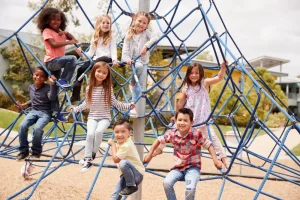 Children climbing school playground equipment